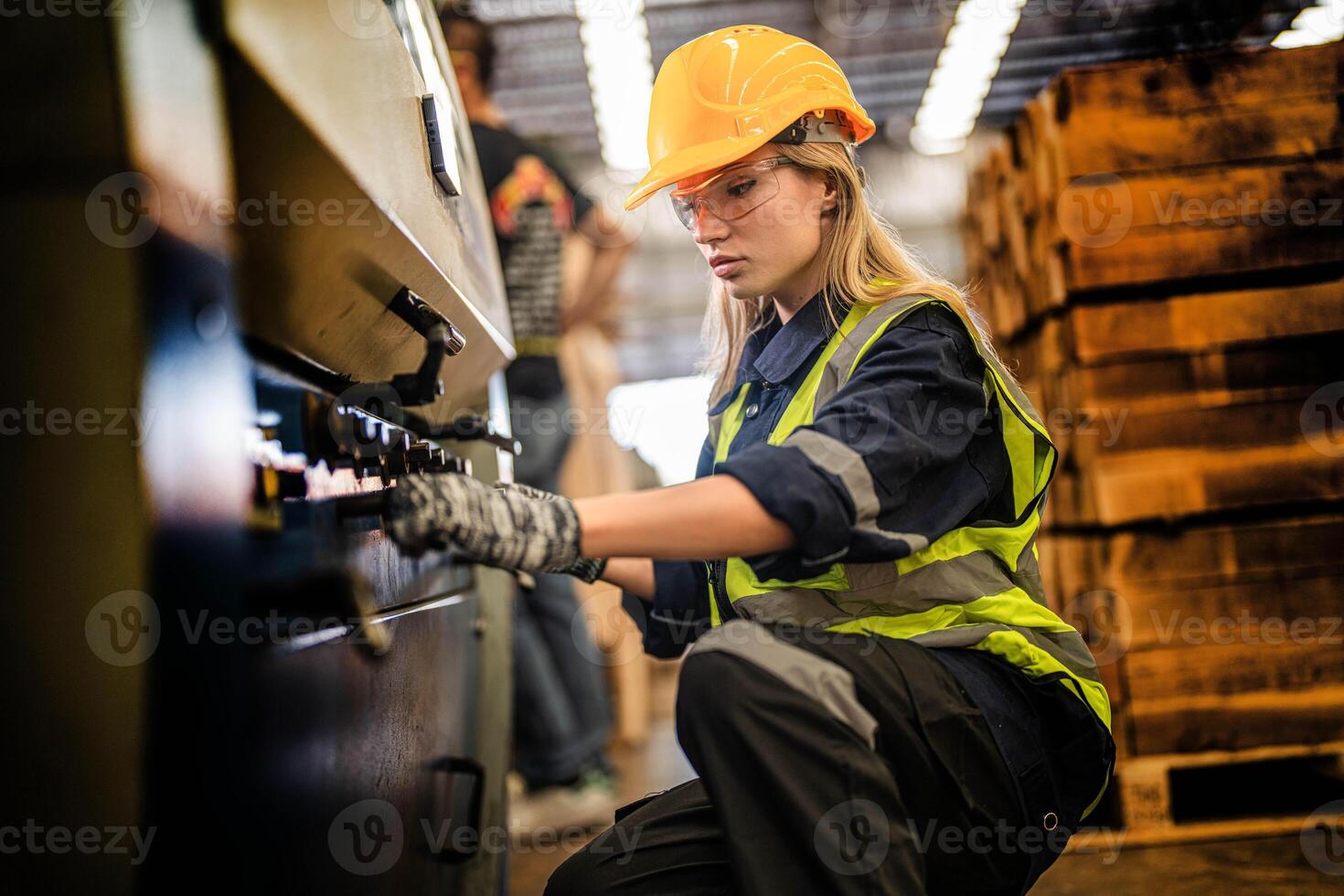 Factory engineer woman standing confidence to control panel switch. Worker works at heavy machine at industry factory. with machinery equipment plant technology. smart industry worker operating. photo