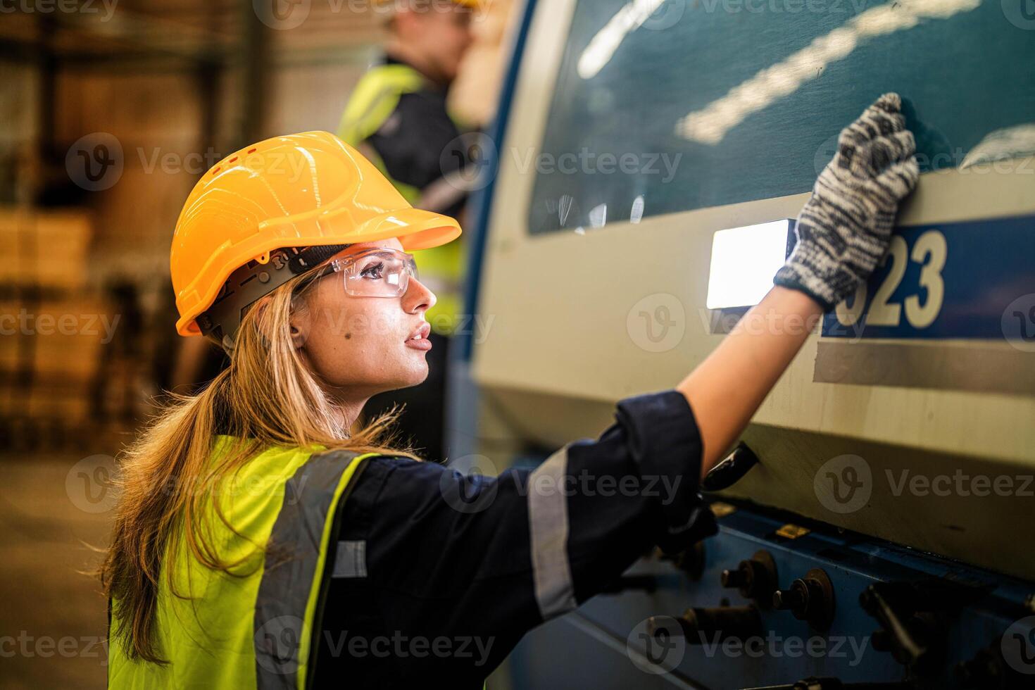 Factory engineer woman standing confidence to control panel switch. Worker works at heavy machine at industry factory. with machinery equipment plant technology. smart industry worker operating. photo
