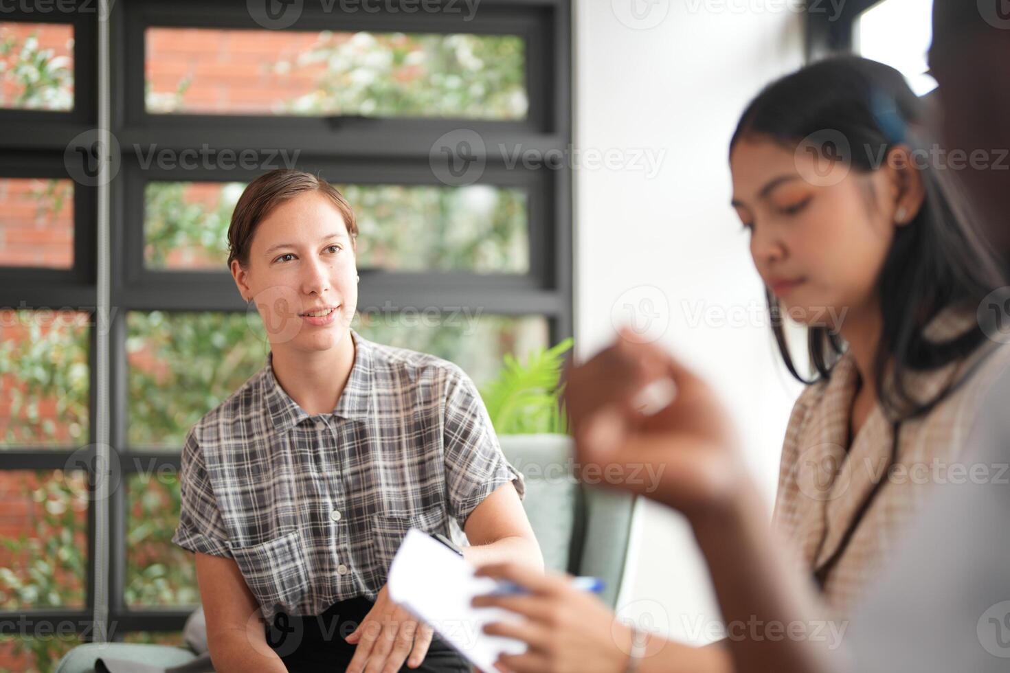 Diverse employees gathered in office having fun during brainstorming while discussing new ideas project. Multiracial coworkers meeting at coworking space area. team of young people in office. photo