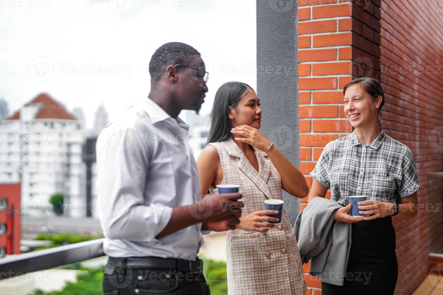 team of business people smart man and women stand at outdoor terrace building and talk together with breakfast food and coffee on the hand in good feeling with city space building. business morning. photo