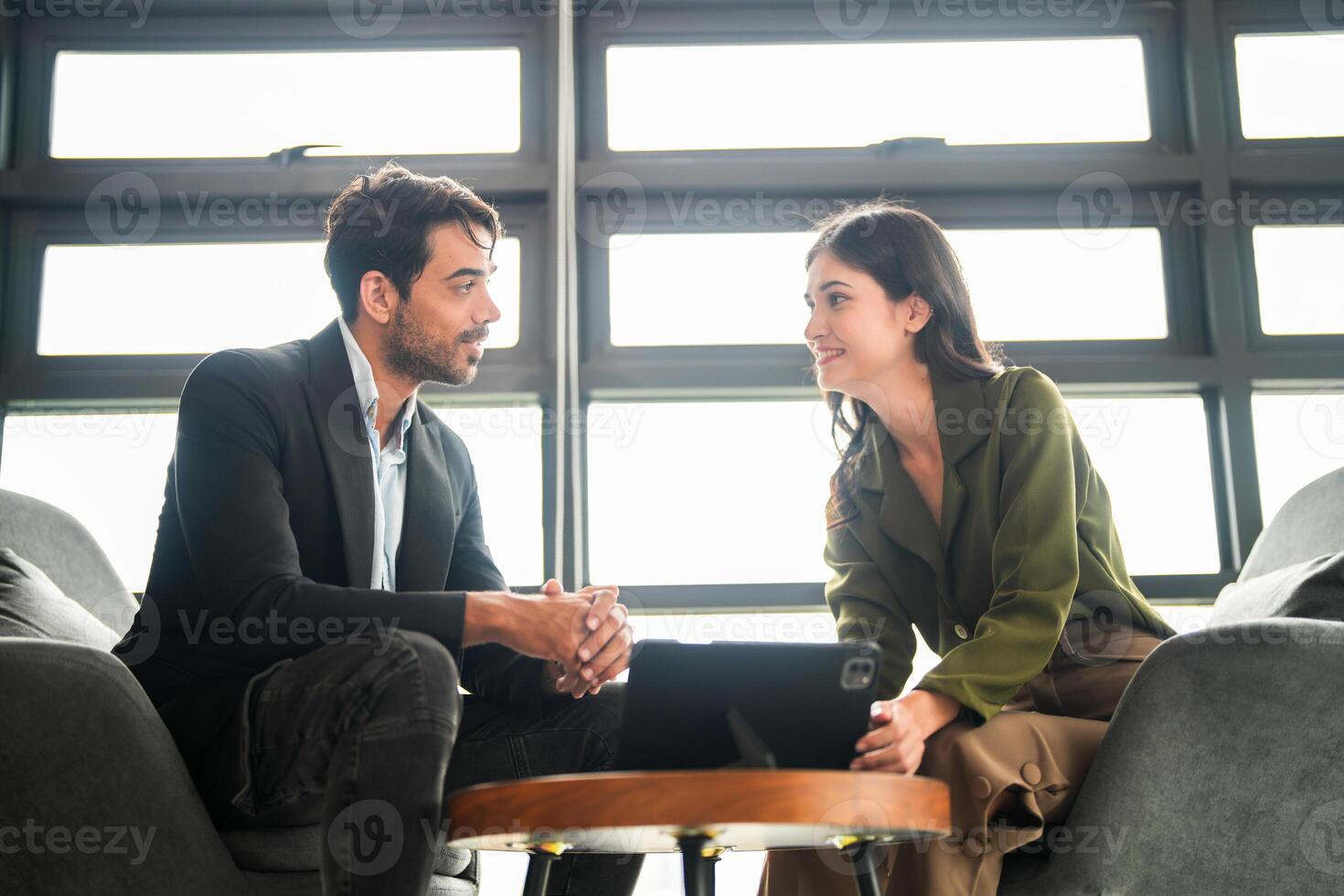 Business people having fun and chatting at workplace office. Male and female colleague enjoy meeting at co working space. colleagues discussing about the project in the office. photo