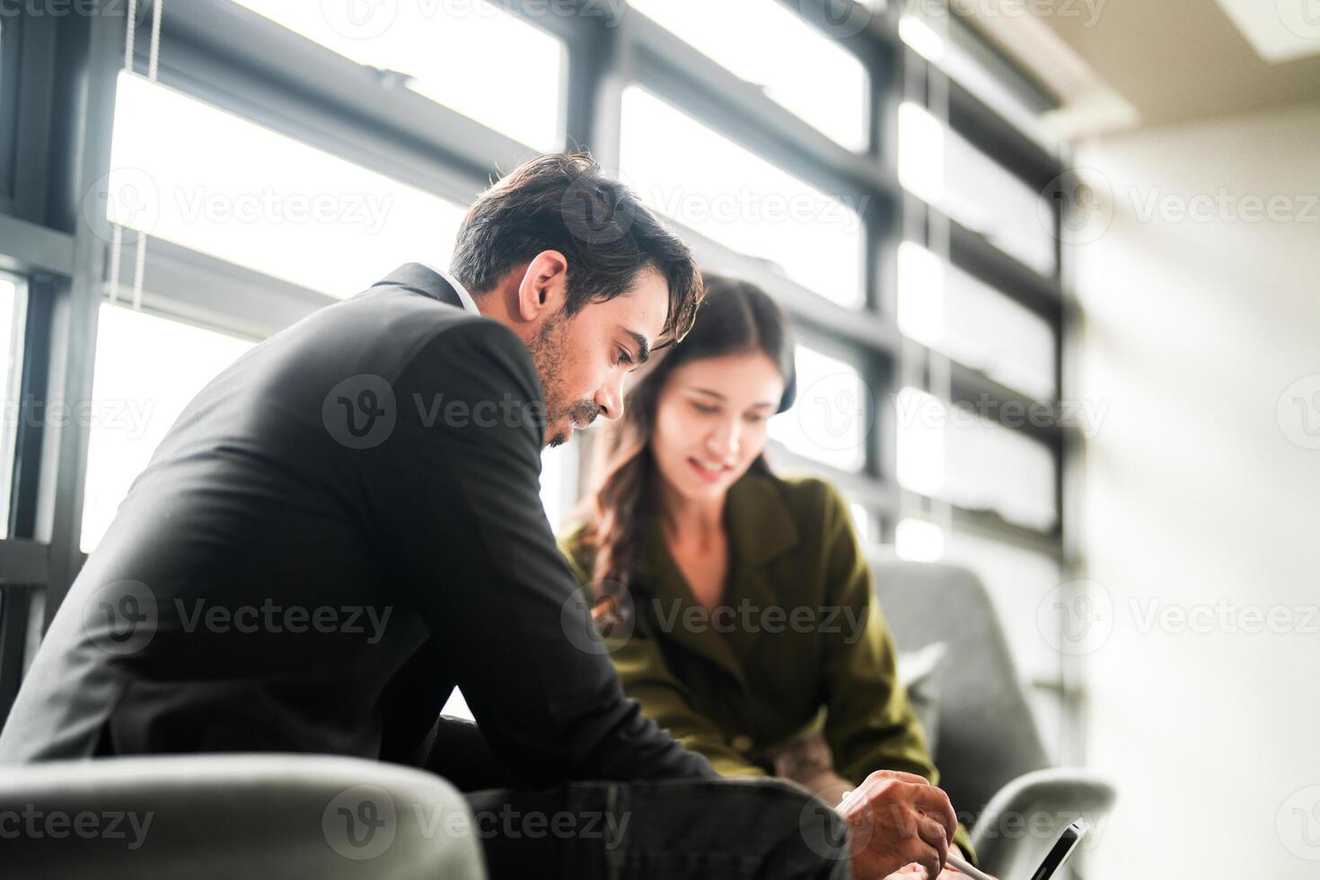 Business people having fun and chatting at workplace office. Male and female colleague enjoy meeting at co working space. colleagues discussing about the project in the office. photo