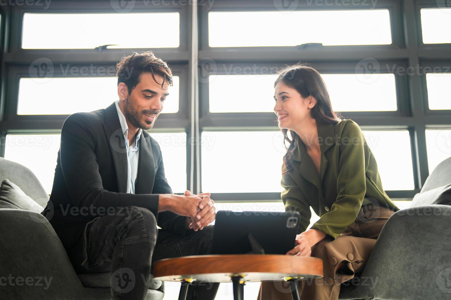 Business people having fun and chatting at workplace office. Male and female colleague enjoy meeting at co working space. colleagues discussing about the project in the office. photo