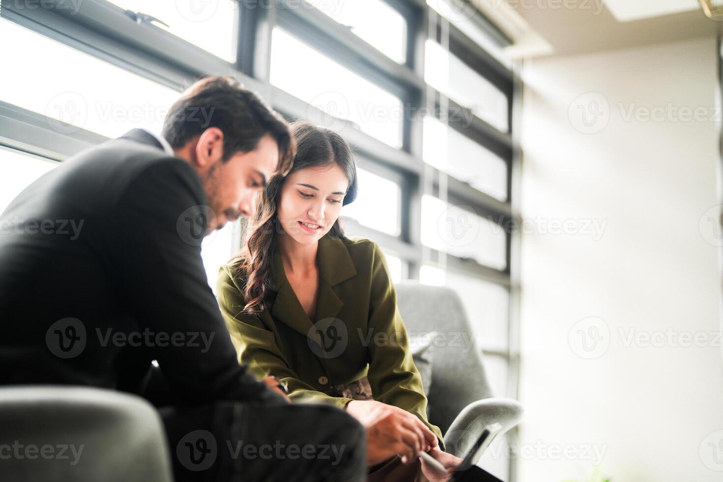 Business people having fun and chatting at workplace office. Male and female colleague enjoy meeting at co working space. colleagues discussing about the project in the office. photo