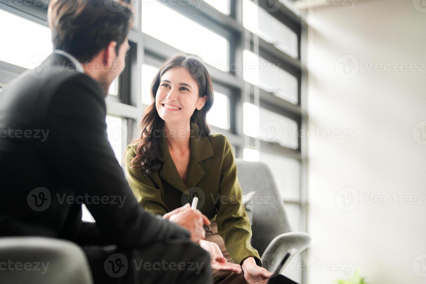 Business people having fun and chatting at workplace office. Male and female colleague enjoy meeting at co working space. colleagues discussing about the project in the office. photo