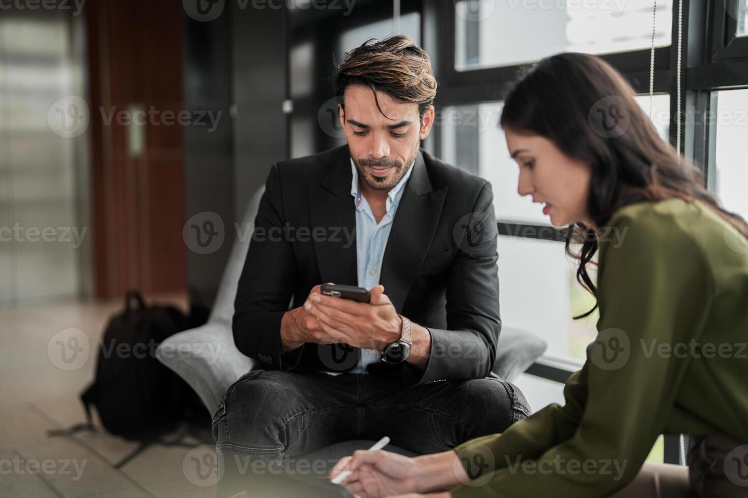 Business people having fun and chatting at workplace office. Male and female colleague enjoy meeting at co working space. colleagues discussing about the project in the office. photo