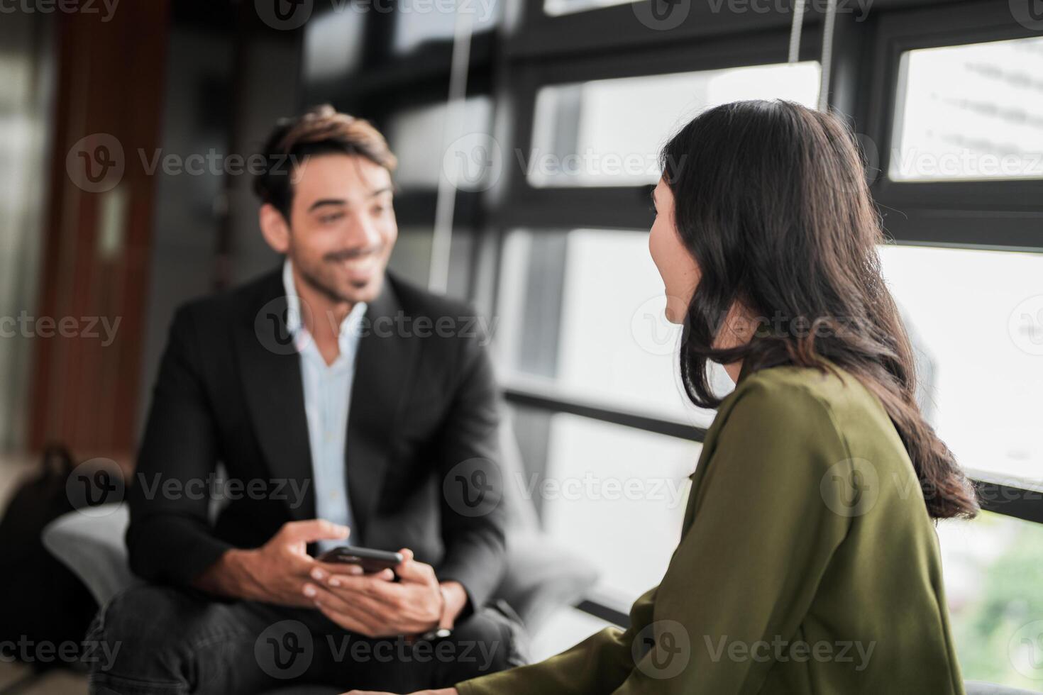 Business people having fun and chatting at workplace office. Male and female colleague enjoy meeting at co working space. colleagues discussing about the project in the office. photo