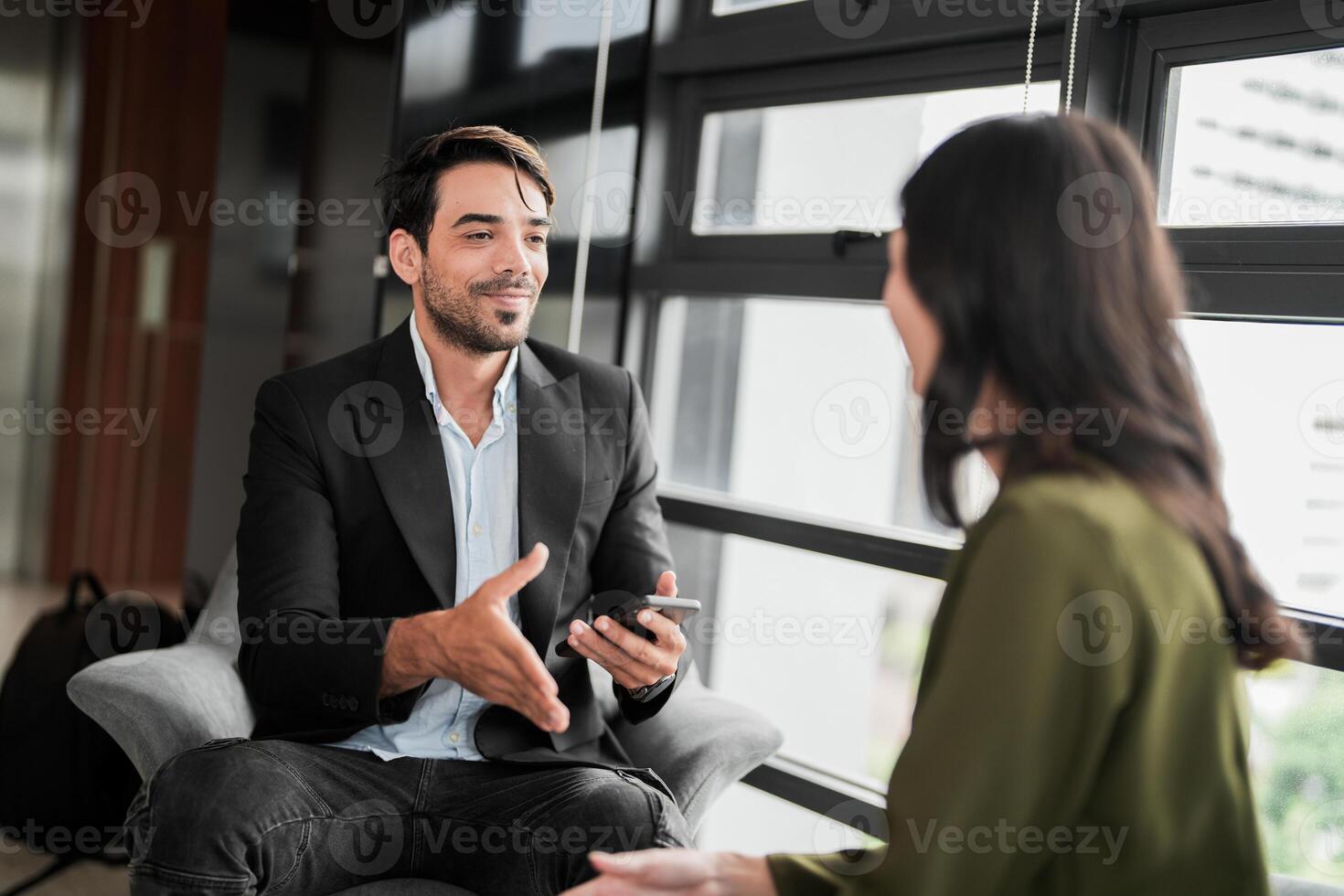 Business people having fun and chatting at workplace office. Male and female colleague enjoy meeting at co working space. colleagues discussing about the project in the office. photo