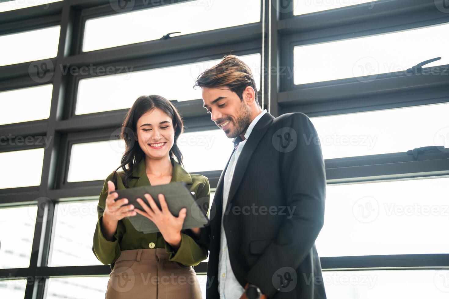 Business people having fun and chatting at workplace office. Male and female colleague enjoy meeting at co working space. colleagues discussing about the project in the office. photo