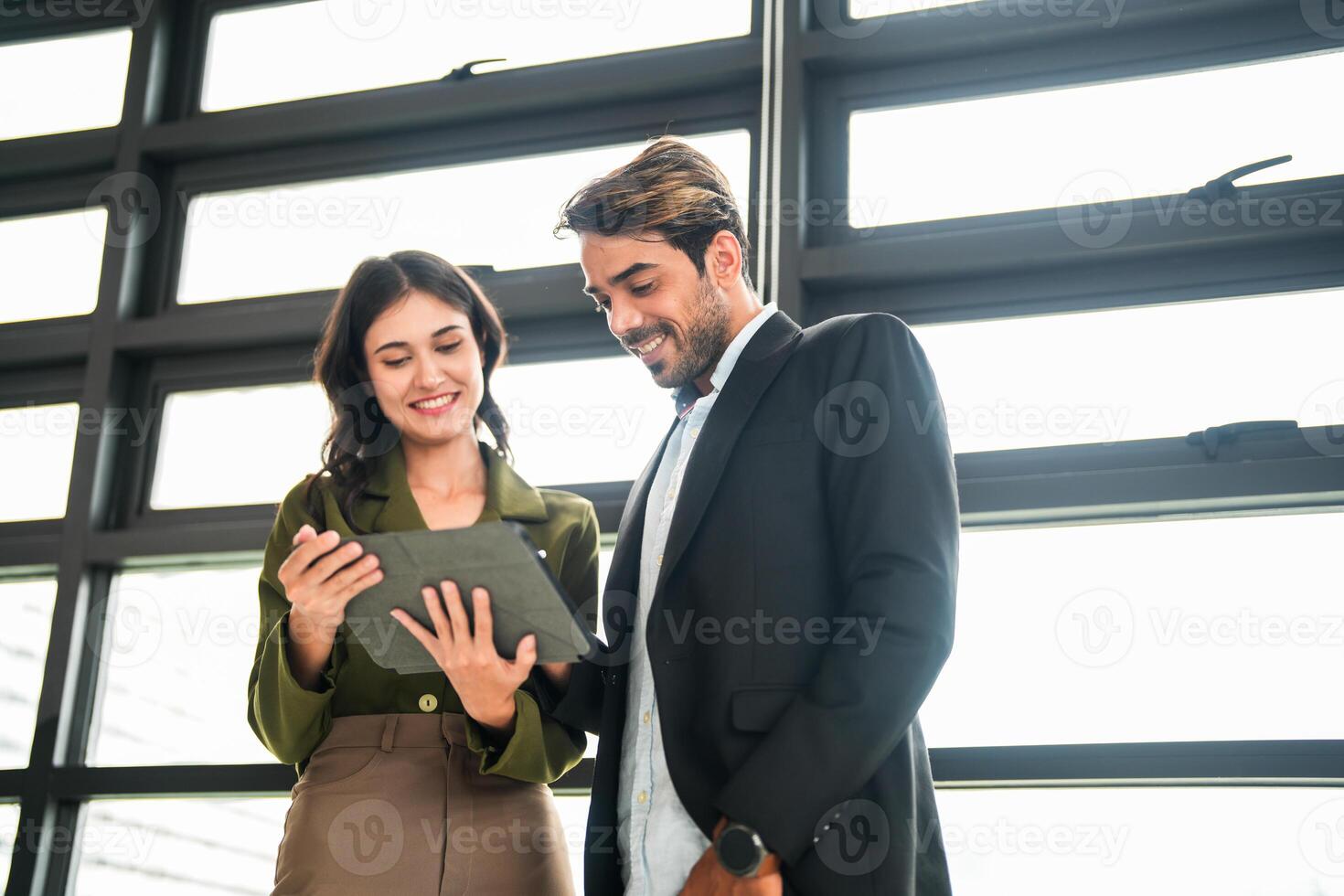 Business people having fun and chatting at workplace office. Male and female colleague enjoy meeting at co working space. colleagues discussing about the project in the office. photo