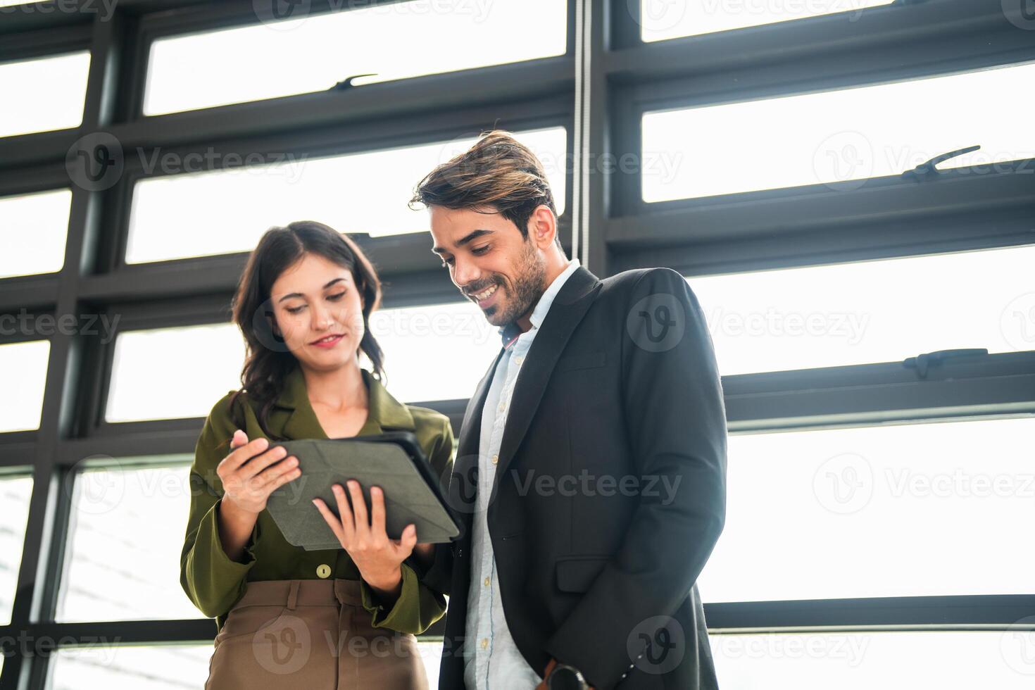 Business people having fun and chatting at workplace office. Male and female colleague enjoy meeting at co working space. colleagues discussing about the project in the office. photo
