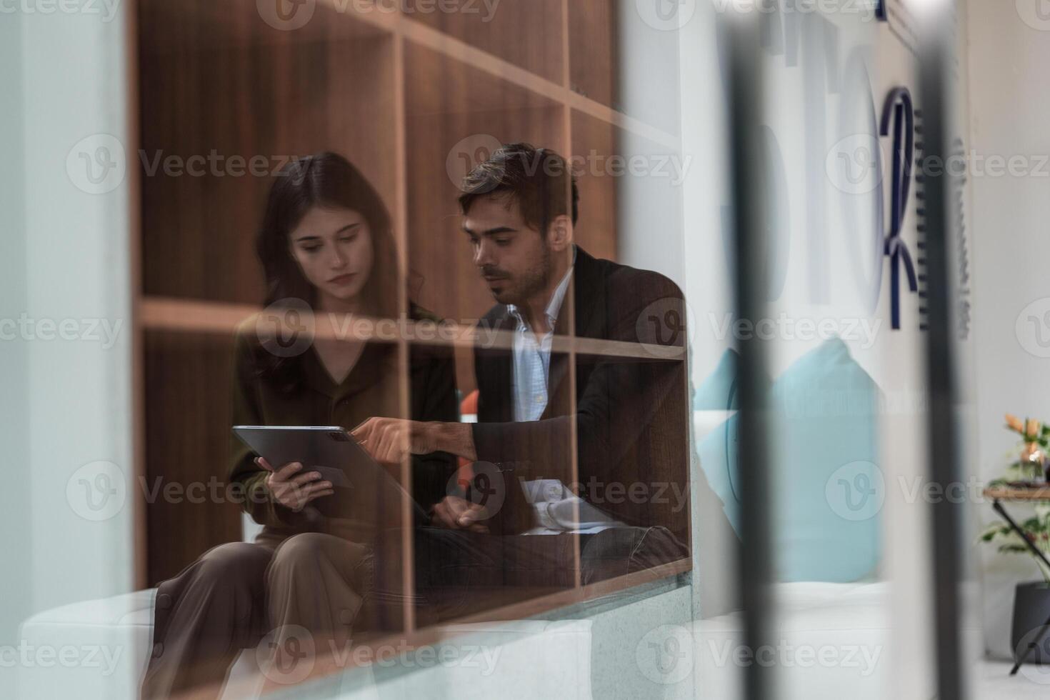 Business people talking at workplace office. Male and female colleagues enjoy relaxing and sitting on sofa. colleagues discussing about the project in the office. team of young people in office. photo