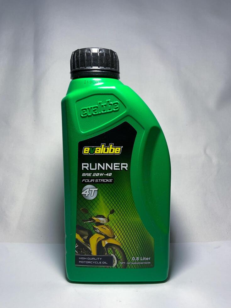 Surakarta, Indonesia, 2023 - Evalube Runner motor oil, high quality motorcycle oil four stroke 4T 800ml. Evalube green bottle packaging. photo