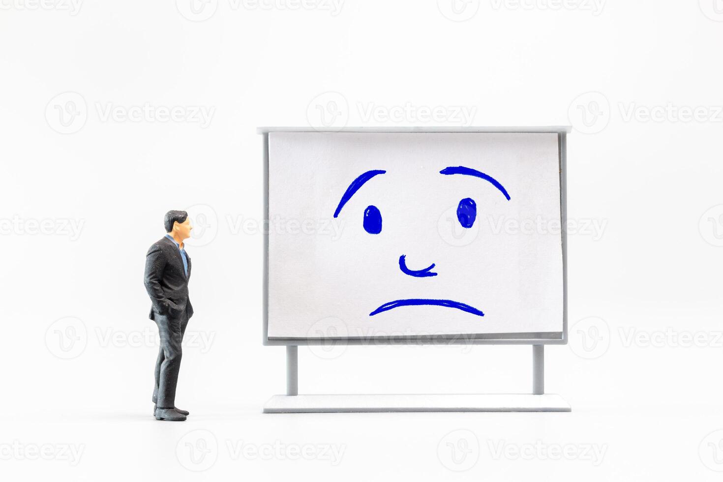 Miniature people, A dejected businessman is positioned in front of a white board, Blue monday concept photo