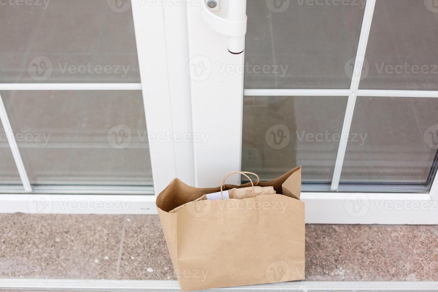 Parcel cardboard box in front door.Door to Door delivery of good merchandises while the quarantine,Delivered outside the door, e-commerce purchase during covid-19 lock down,Social Distance concept. photo