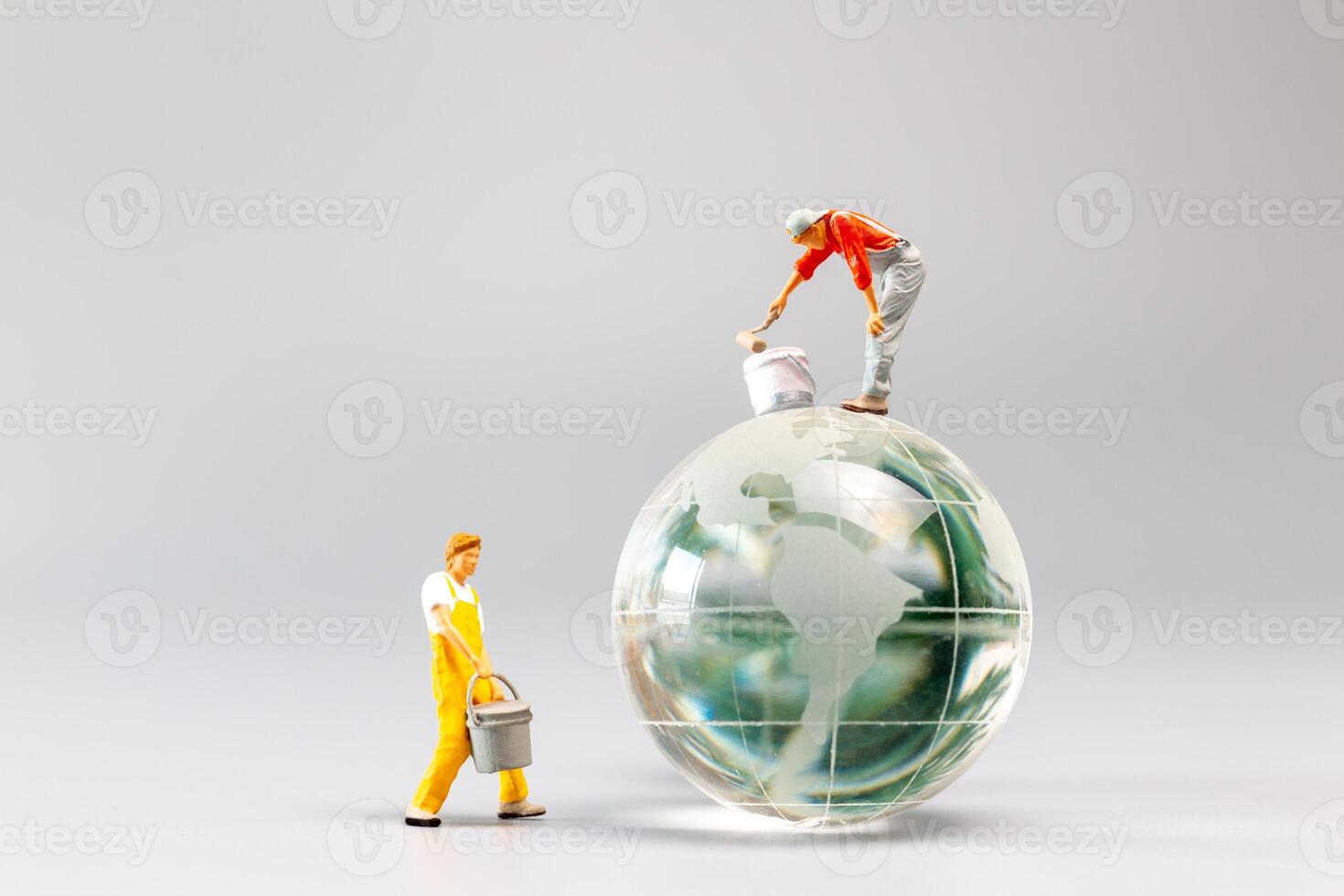 Painters are polishing a crystal globe, and the concept of World Earth Day photo