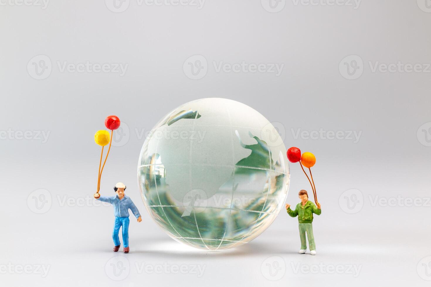 A joyful family with a balloon encircling a crystal globe  and the conncept of World Earth Day photo