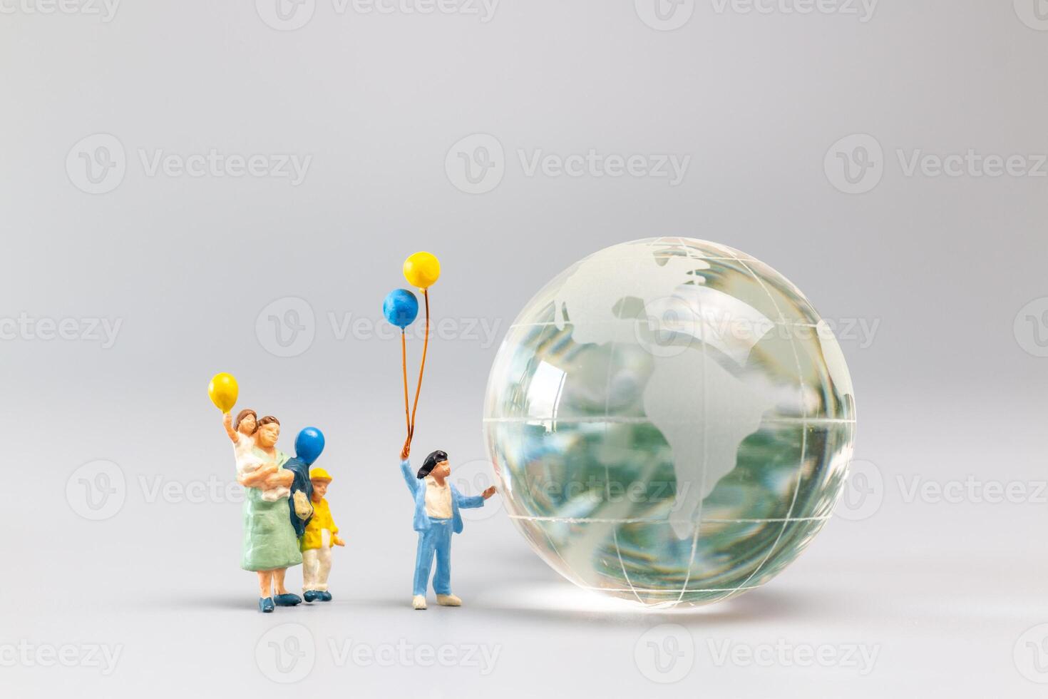 A joyful family with a balloon encircling a crystal globe  and the conncept of World Earth Day photo