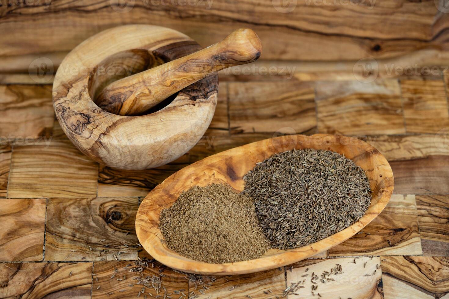 caraway seeds Carum carvi on olive wood photo