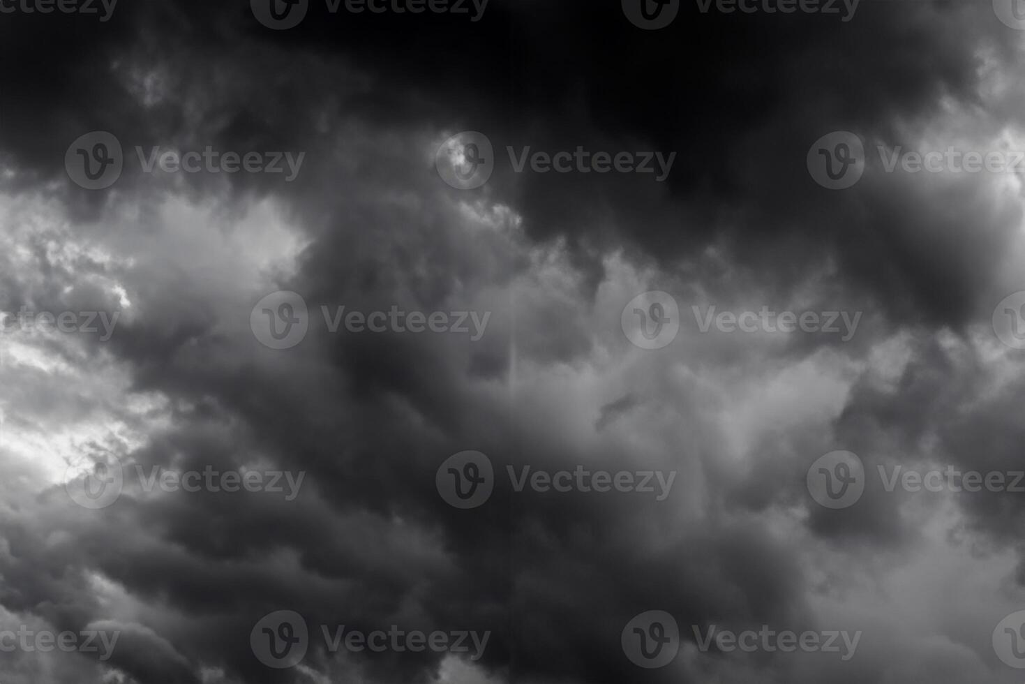 Dark sky and dramatic black cloud before rain.A tropical cyclone is a rapidly rotating storm system characterized by a low-pressure center, a closed low-level atmospheric circulation, strong winds. photo