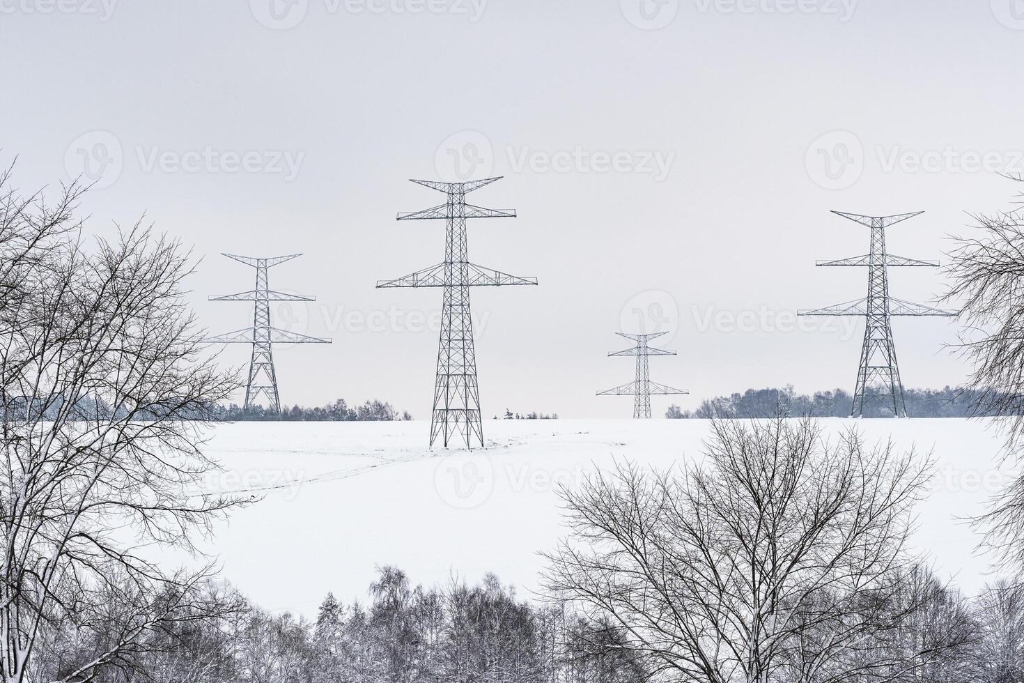 Construction of high voltage pylons in winter. Assembled power transmission line supports, ready for installation. photo