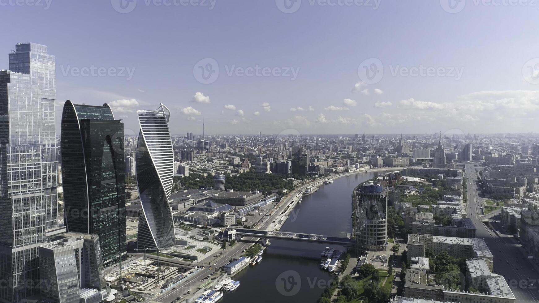 Stunning landscape of skyscrapers near Moscow river and Bagration bridge at daytime, Russia. Action. Aerial for high modern buildings with glass facade. photo