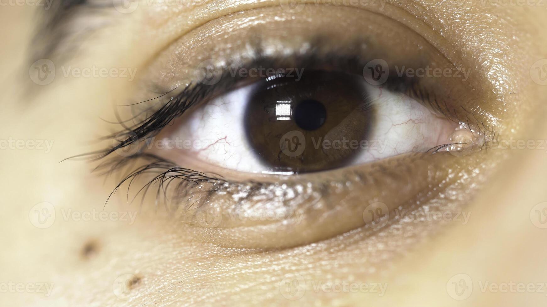 Close up picture of beautiful brown eye of a young man, face detail concept. Media. The pupil of male eye narrows and widens. photo