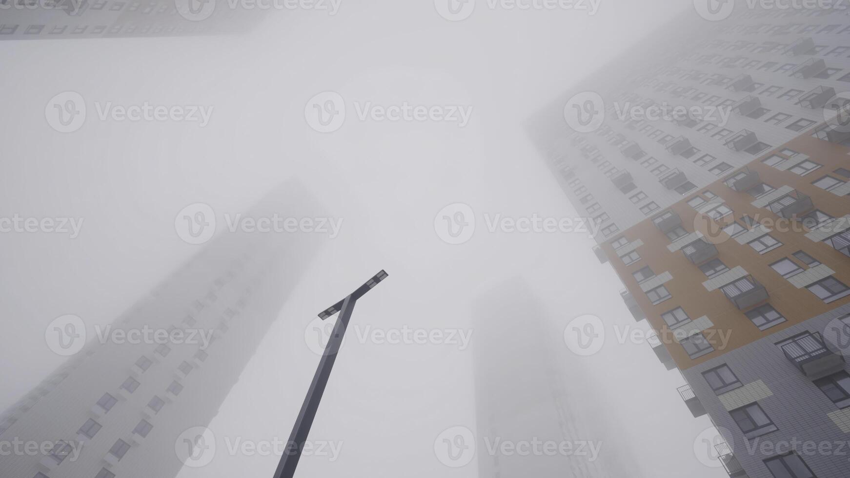 Residential high-rise buildings in fog. Action. Bottom view of high-rise buildings shrouded in thick fog. Cloudy weather with fog envelops high-rise buildings photo