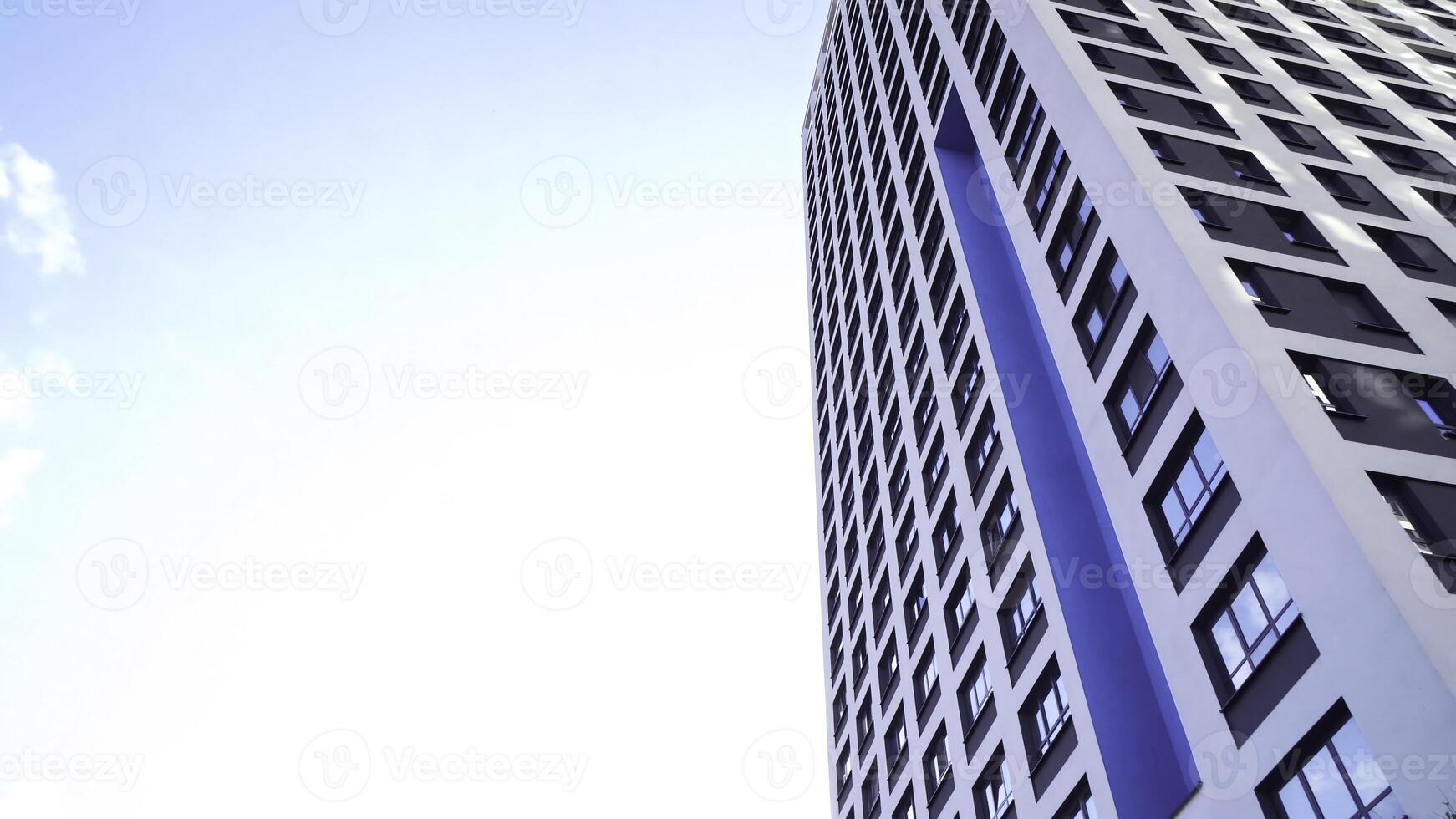Bottom view of new residential high-rise buildings with blue sky. Urban environment. Frame. Newest residential complexes with an eco-friendly environment photo