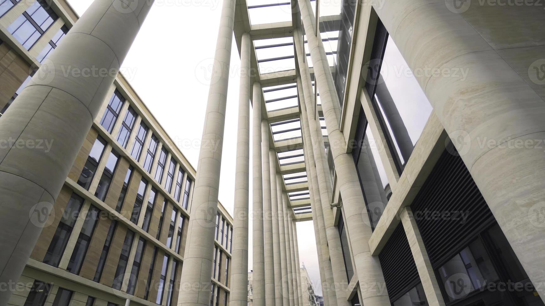 Beautiful colonnade of modern business building. Action. External corridor with rows of columns of business center. Ancient solutions in architecture of modern buildings photo