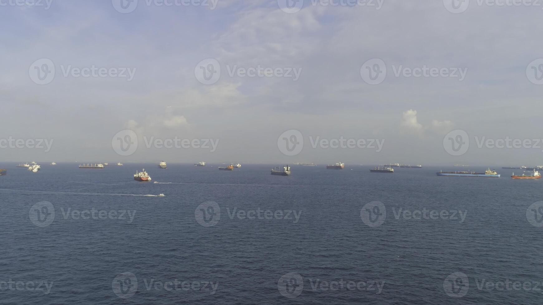 Crude Oil tanker and LPG Loading in port at sea view from above. Shot. Landscape from bird view of Cargo ships entering one of the busiest ports in the world, Singapore photo