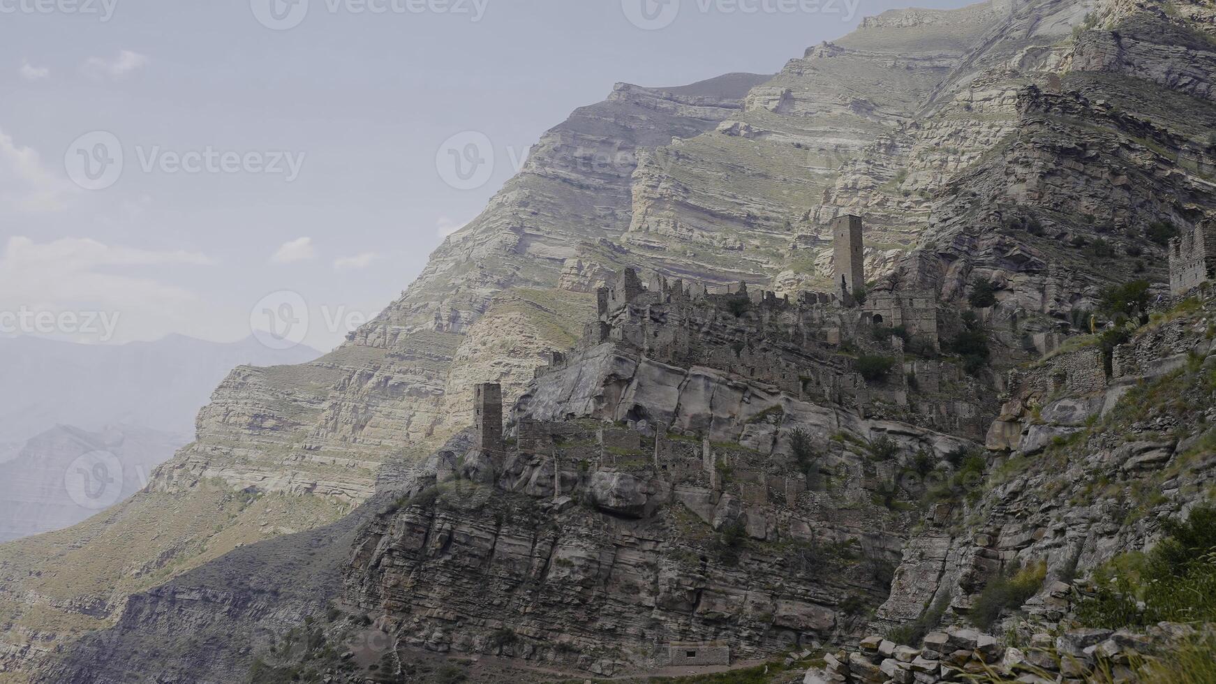 Top view of amazing stone city in mountains. Action. Ancient stone city on rock in mountains. Abandoned stone city in mountains photo