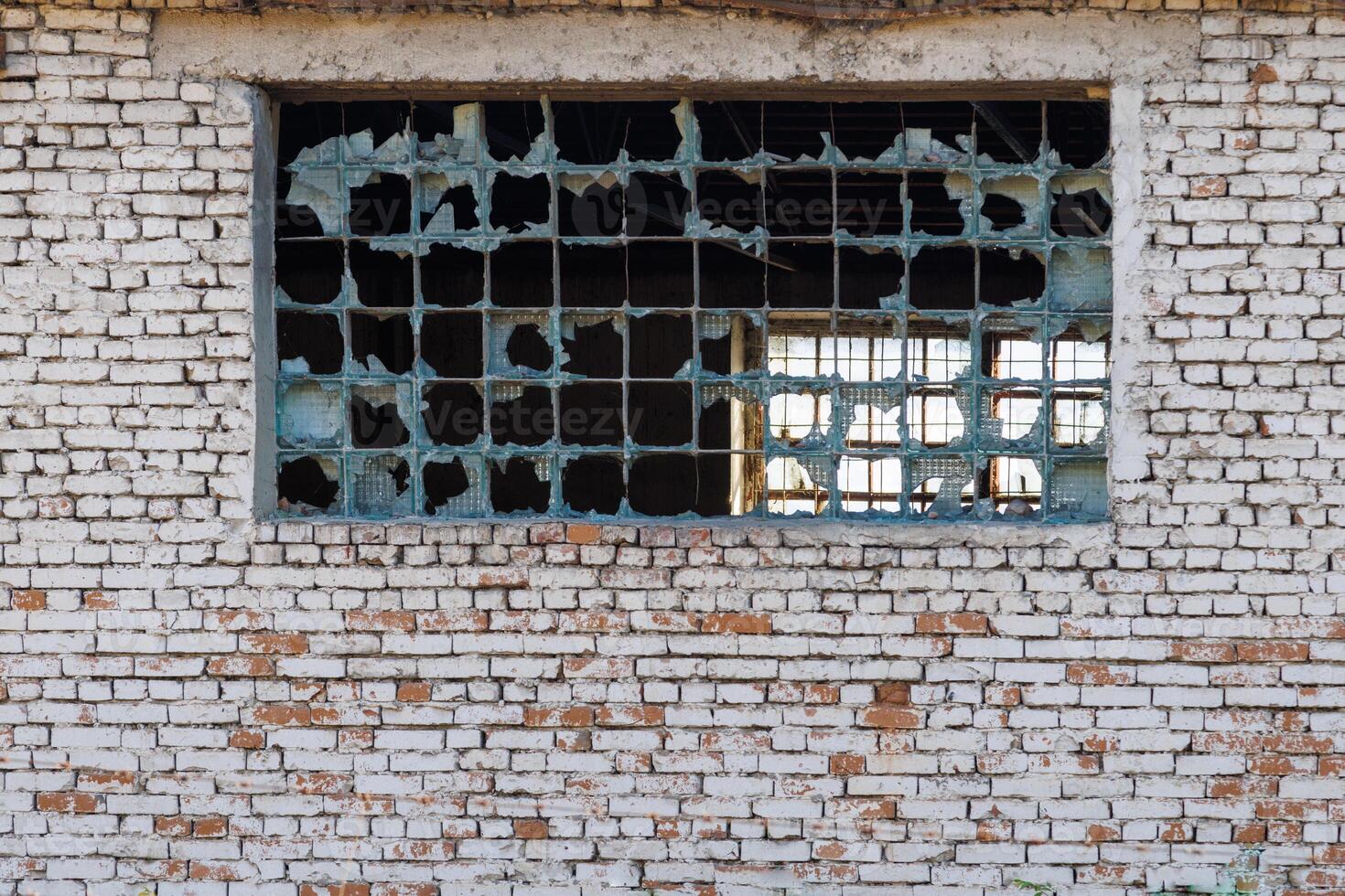 broken glass block window in white brick wall texture and background photo