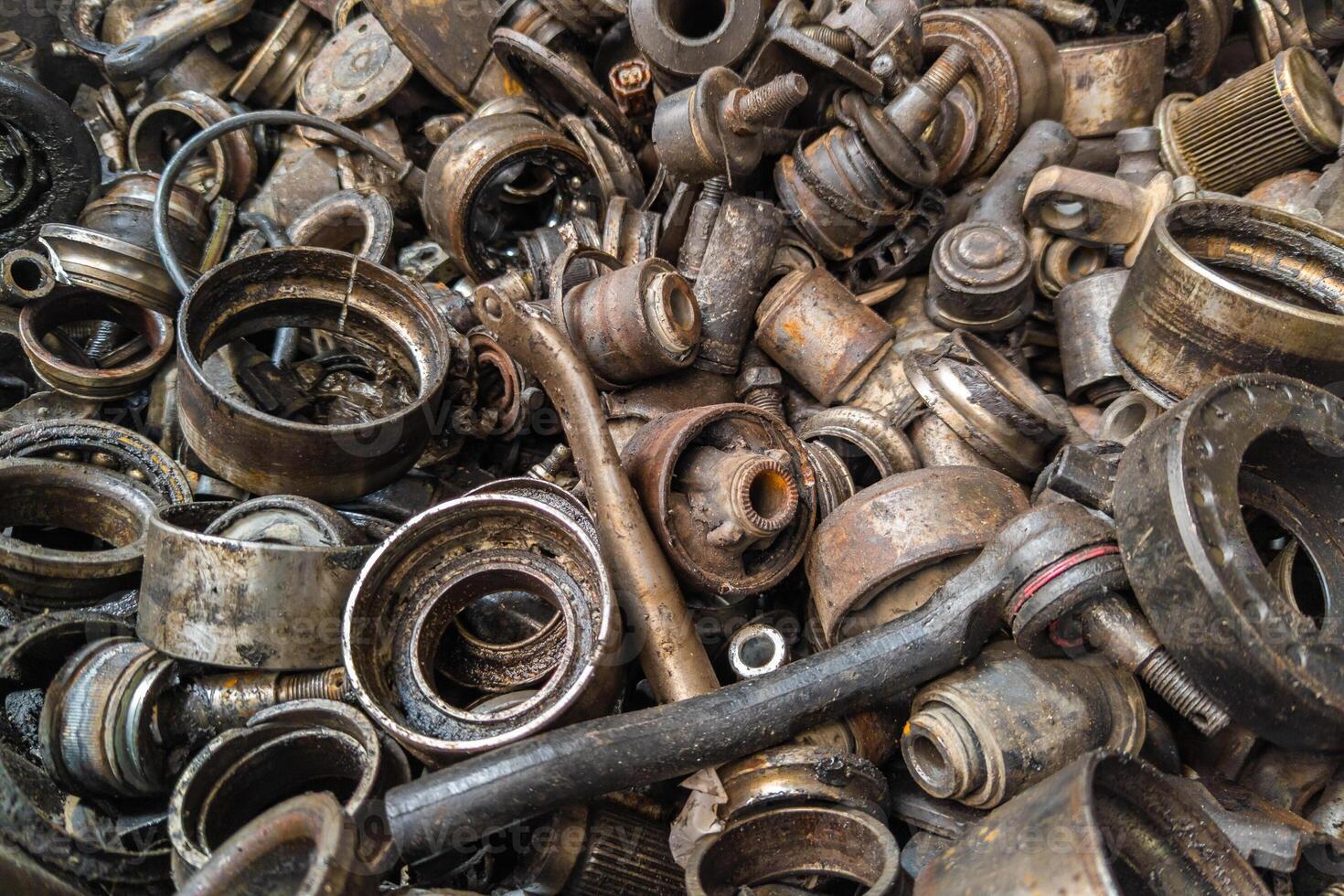 rusted steel scrap pile of used car parts and pieces photo