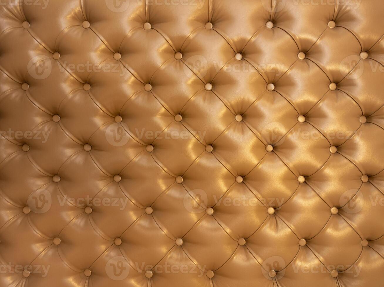 Texture of brown beige leather background with capitone pattern, full-frame. Brown retro Chesterfield style. photo