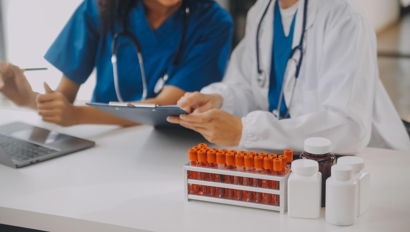 biochemical research scientist team working with microscope for coronavirus vaccine development in pharmaceutical research labolatory, selective focus photo