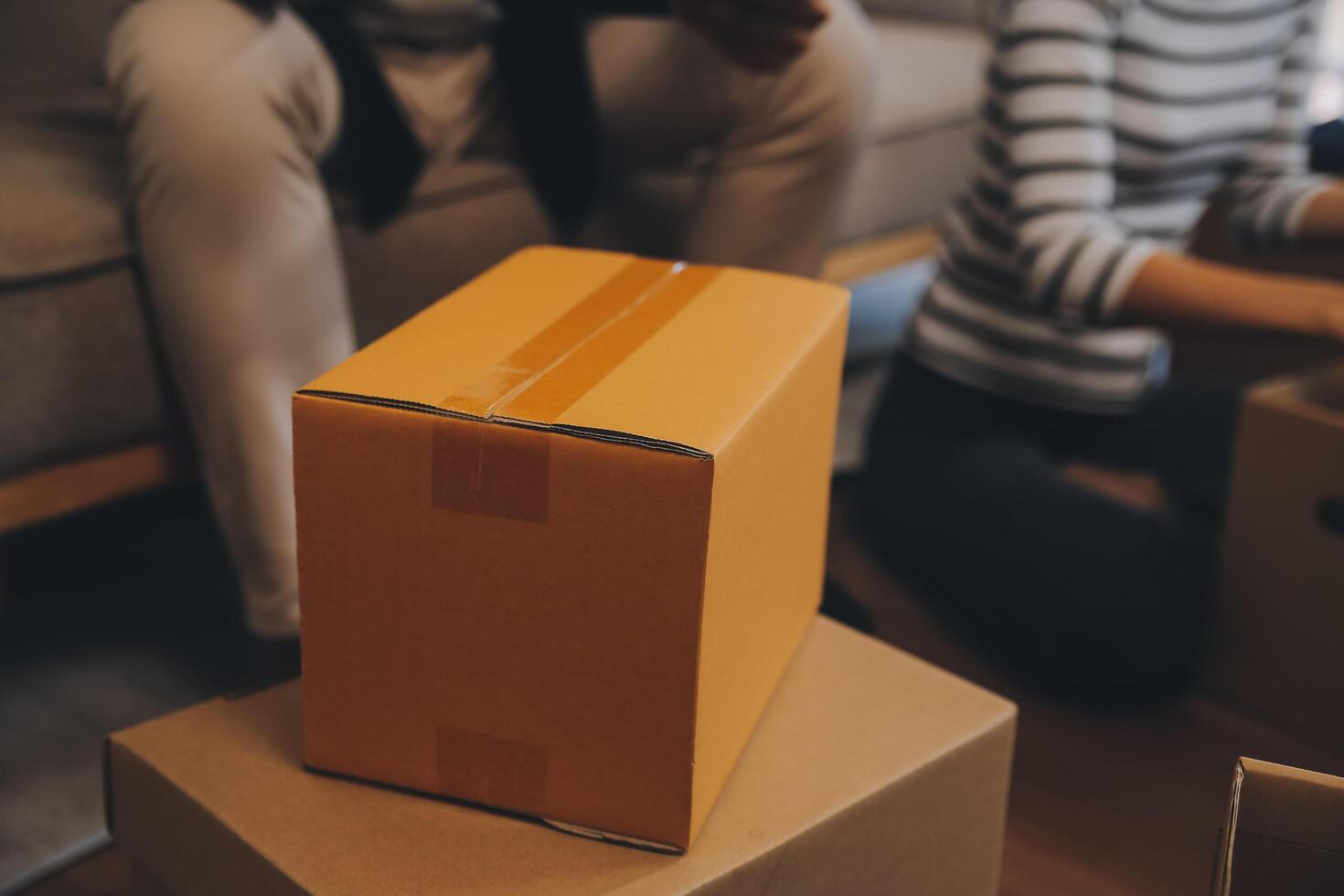 Two Asian blogger showing clothes in front of the camera to recording vlog video live streaming at her shop. Online Shopping Cart notion. on sofa at home photo