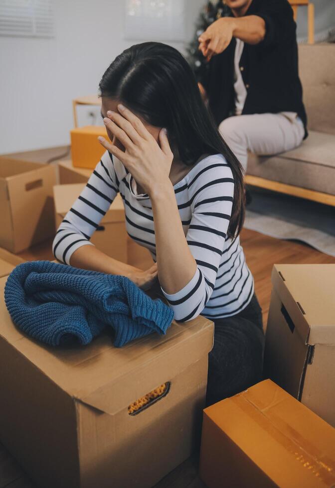 Two Asian blogger showing clothes in front of the camera to recording vlog video live streaming at her shop. Online Shopping Cart notion. on sofa at home photo