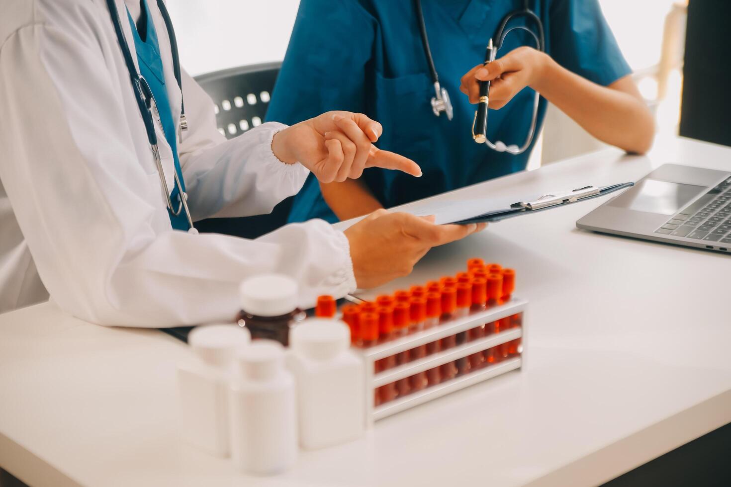 biochemical research scientist team working with microscope for coronavirus vaccine development in pharmaceutical research labolatory, selective focus photo