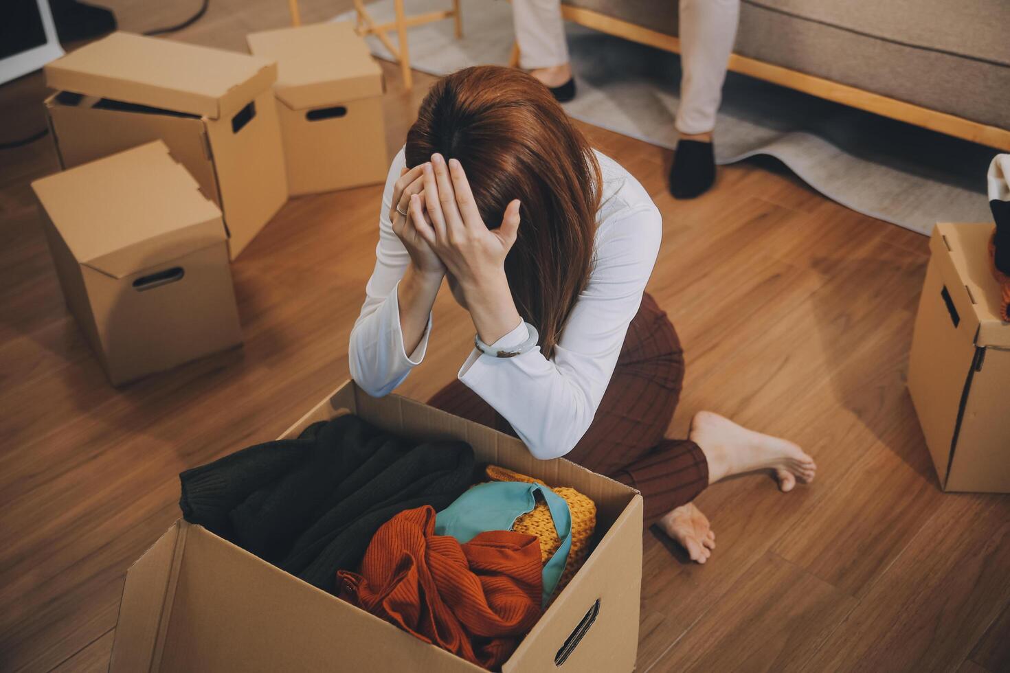 Two Asian blogger showing clothes in front of the camera to recording vlog video live streaming at her shop. Online Shopping Cart notion. on sofa at home photo