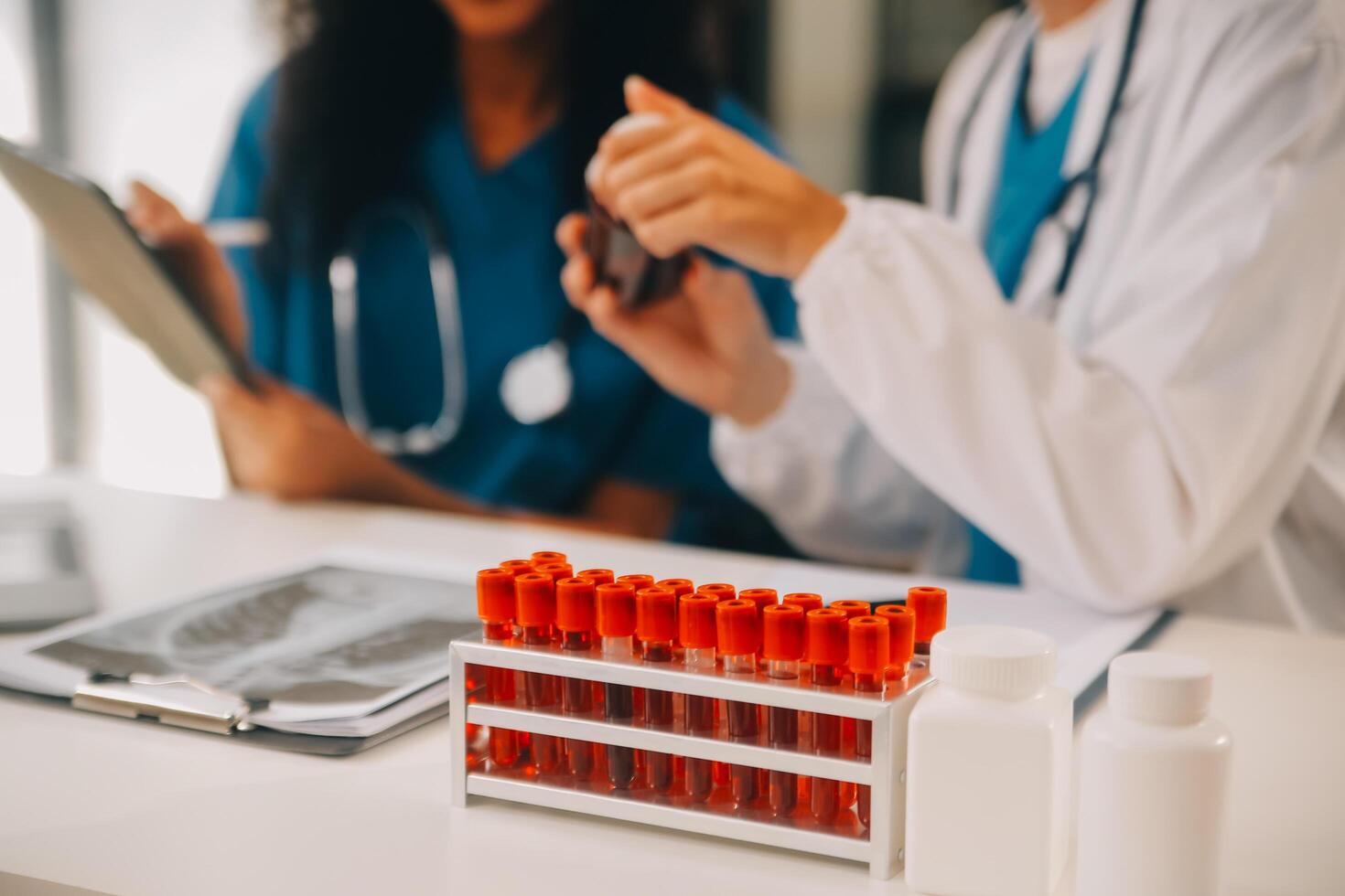 biochemical research scientist team working with microscope for coronavirus vaccine development in pharmaceutical research labolatory, selective focus photo