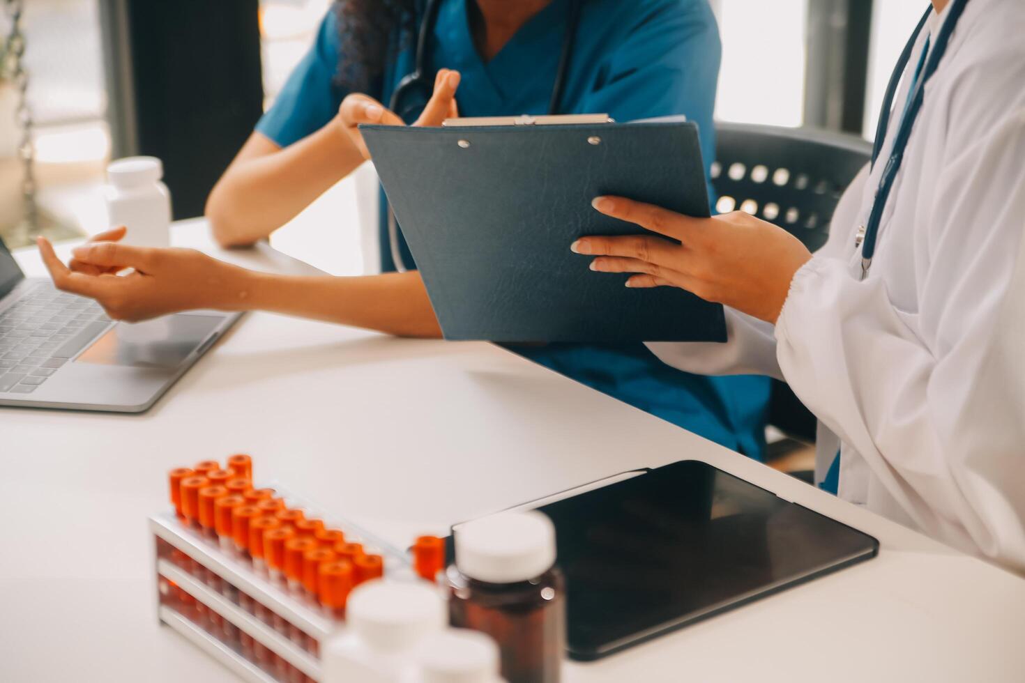 biochemical research scientist team working with microscope for coronavirus vaccine development in pharmaceutical research labolatory, selective focus photo