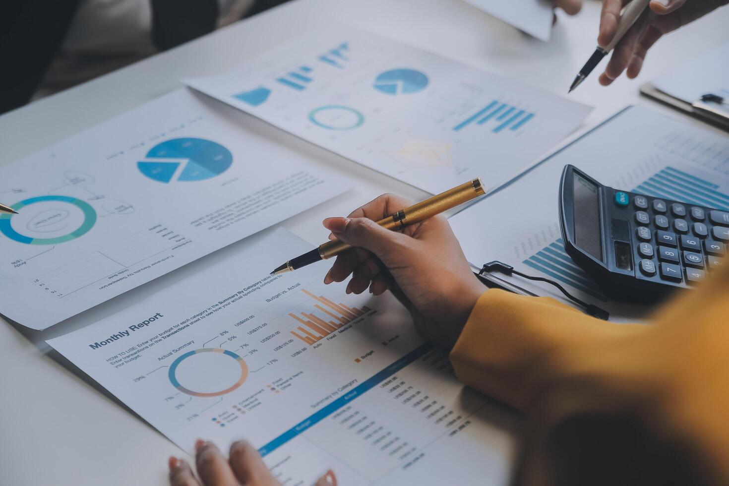 Financial analysts analyze business financial reports on a digital tablet planning investment project during a discussion at a meeting of corporate showing the results of their successful teamwork. photo