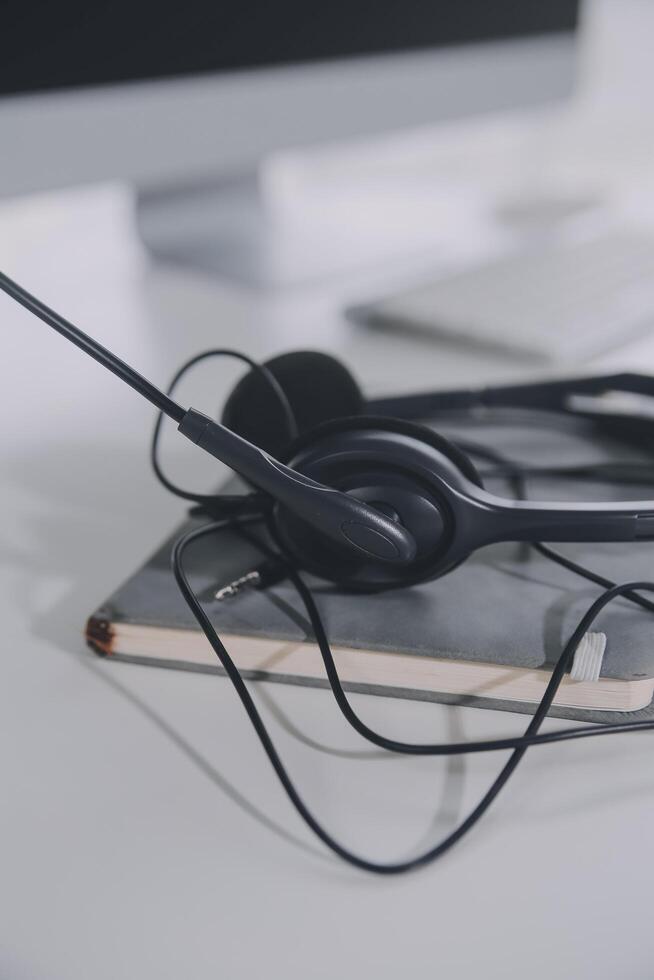 Communication support, call center and customer service help desk. VOIP headset on telephone keyboard. photo