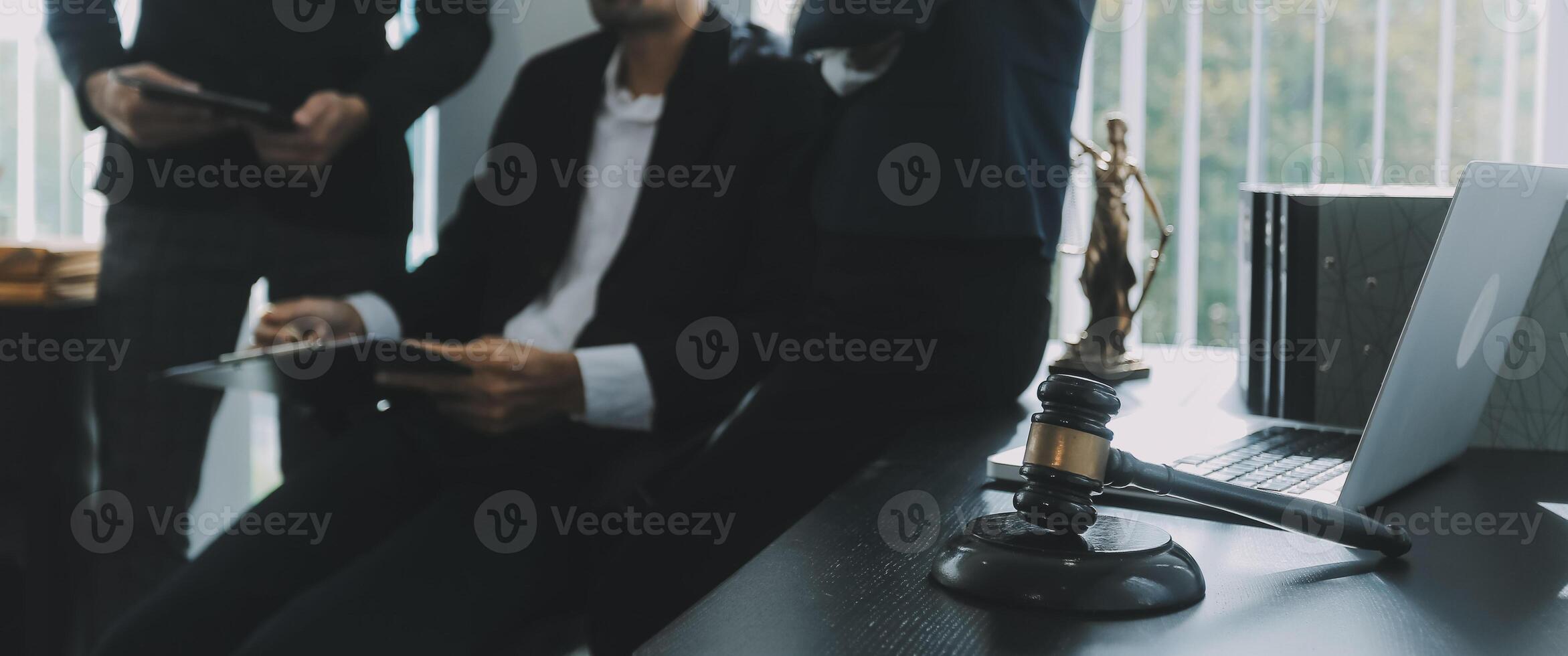 Group of experienced attorneys and lawyers giving consultation to client, helping with difficult lawsuit, explaining legal procedures and discussing agreement terms. Law services and support concept photo
