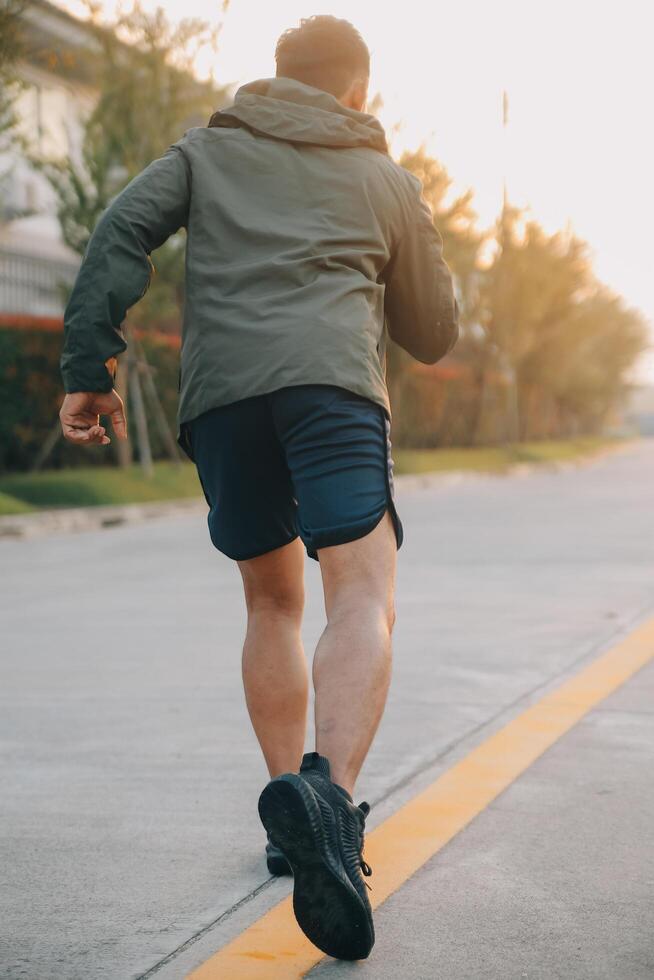 Athlete runner feet running on road,Jogging concept at outdoors. Man running for exercise.Athlete runner feet running on road, Jogging concept at outdoors. Man running for exercise. photo