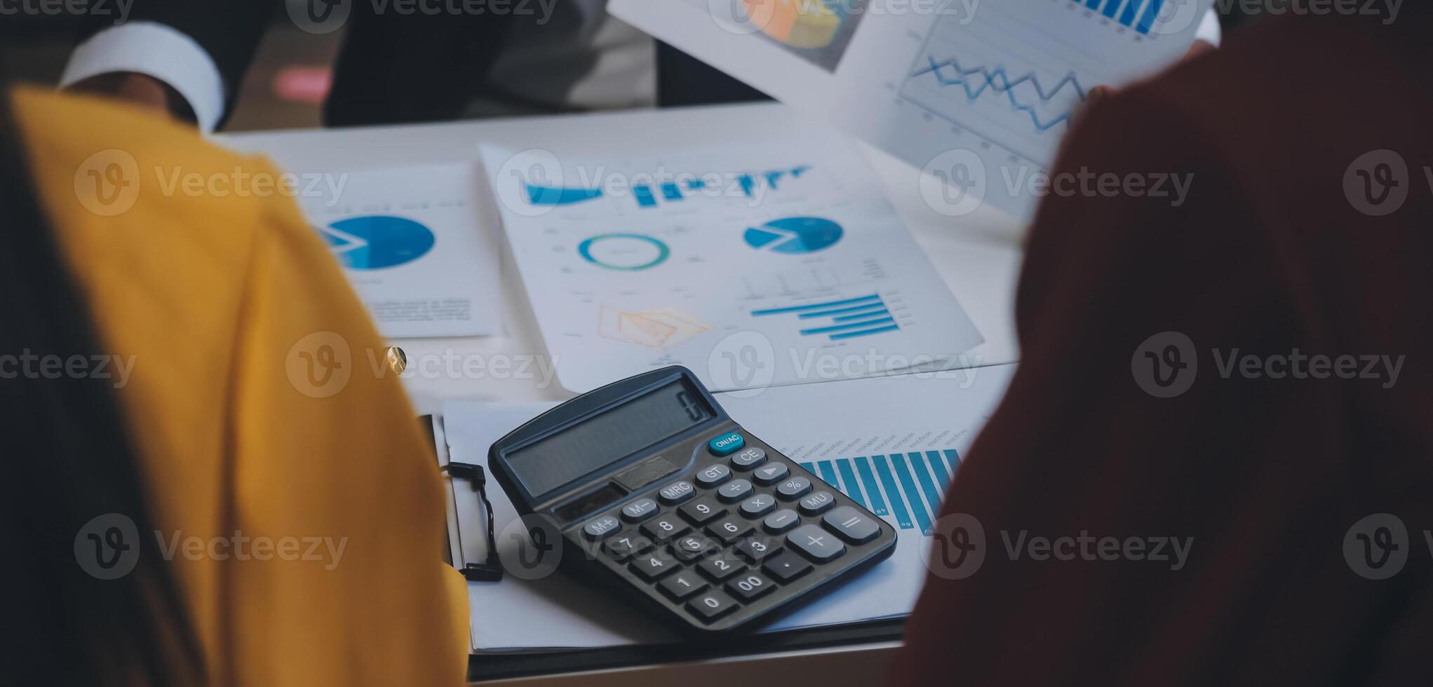 Financial analysts analyze business financial reports on a digital tablet planning investment project during a discussion at a meeting of corporate showing the results of their successful teamwork. photo