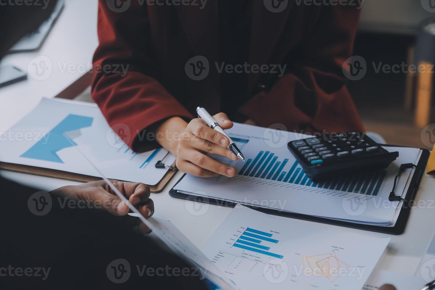 Financial analysts analyze business financial reports on a digital tablet planning investment project during a discussion at a meeting of corporate showing the results of their successful teamwork. photo