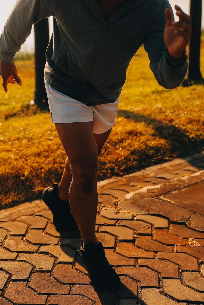 Athlete runner feet running on road,Jogging concept at outdoors. Man running for exercise.Athlete runner feet running on road, Jogging concept at outdoors. Man running for exercise. photo