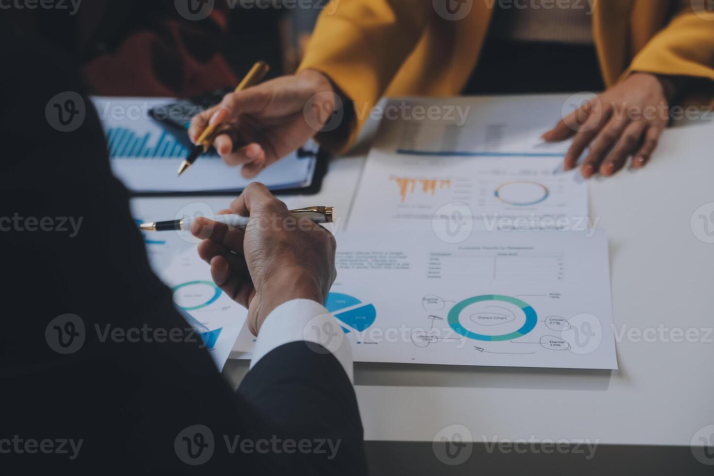Financial analysts analyze business financial reports on a digital tablet planning investment project during a discussion at a meeting of corporate showing the results of their successful teamwork. photo
